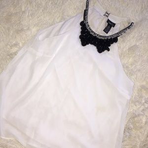 White blouse with black collar.